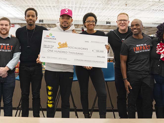 Chance the Rapper holding a grant check for Conagra's SocialWorks program